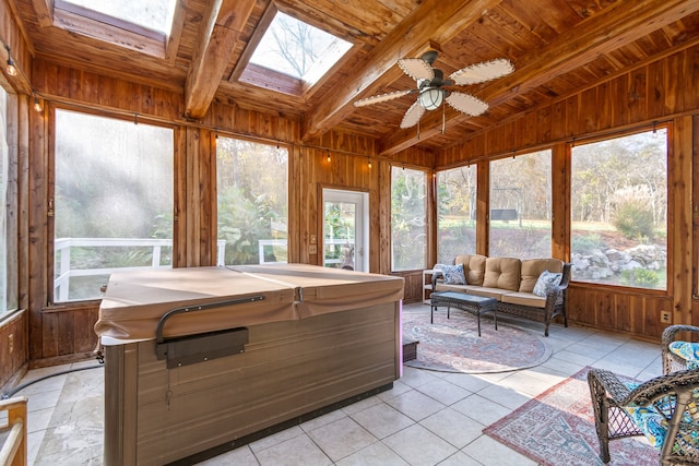 sunroom with vaulted ceiling with skylight, ceiling fan, wood ceiling, and a hot tub