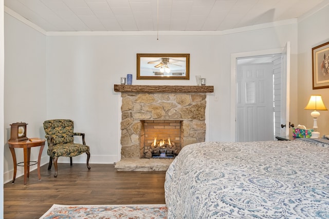 bedroom featuring a fireplace, dark hardwood / wood-style flooring, and ornamental molding