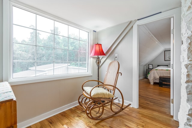 sitting room featuring vaulted ceiling and light wood-type flooring