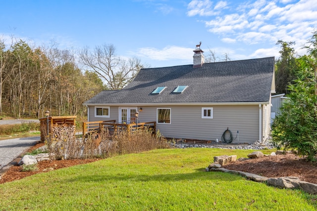 back of property with a yard and french doors