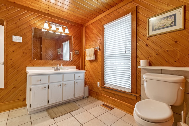 bathroom featuring tile patterned flooring, plenty of natural light, and wooden walls