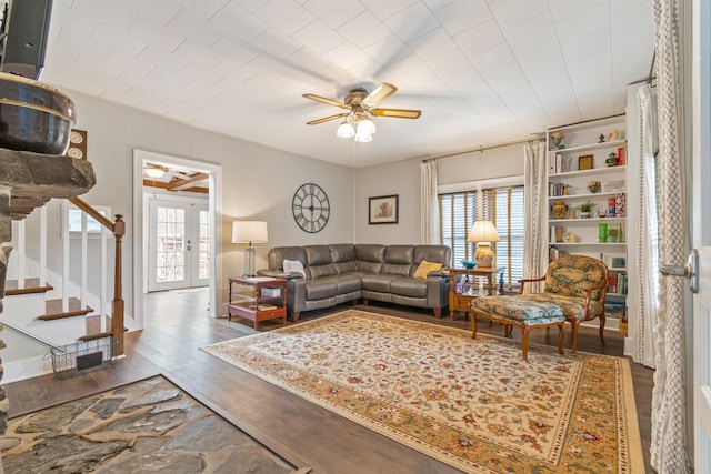 living room featuring dark hardwood / wood-style floors, ceiling fan, and french doors