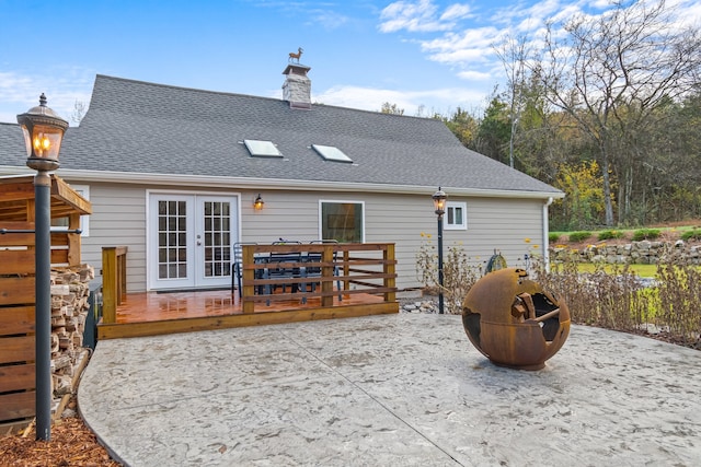 rear view of house featuring french doors and a wooden deck