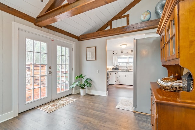 doorway featuring french doors, vaulted ceiling with beams, dark hardwood / wood-style floors, and a healthy amount of sunlight