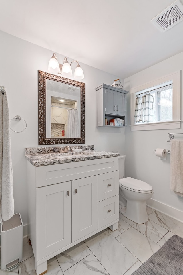 bathroom with vanity, toilet, and curtained shower