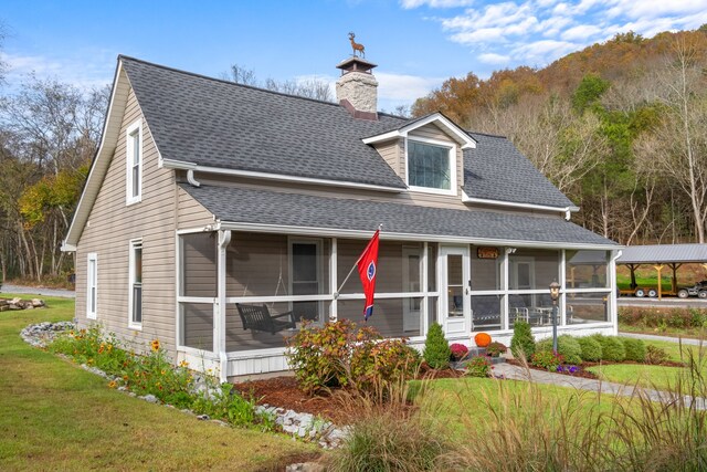 view of front of house featuring a sunroom