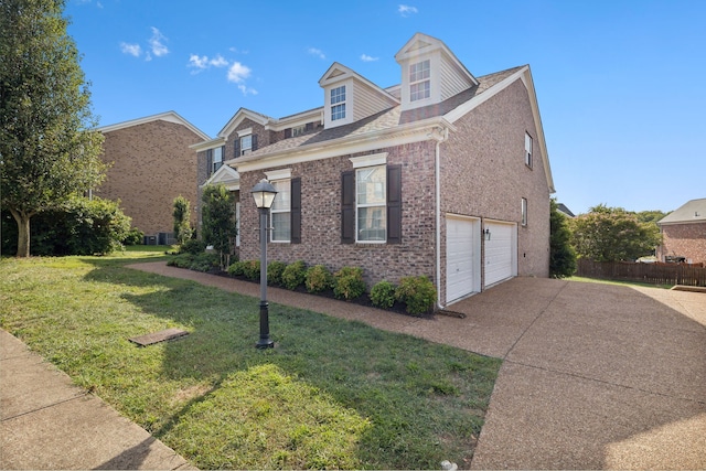 view of front of home featuring a front yard and a garage