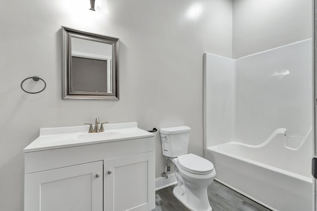 full bathroom with toilet, vanity, bathtub / shower combination, and hardwood / wood-style flooring