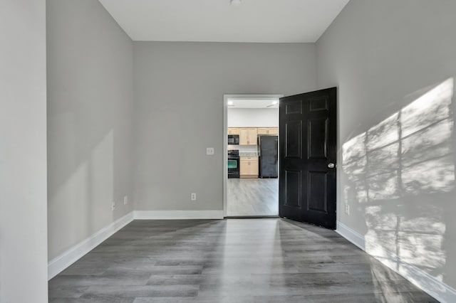 unfurnished room with hardwood / wood-style floors