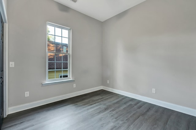 empty room with dark hardwood / wood-style flooring