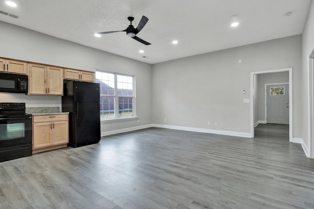 kitchen featuring light brown cabinets, black appliances, light hardwood / wood-style flooring, ceiling fan, and a textured ceiling