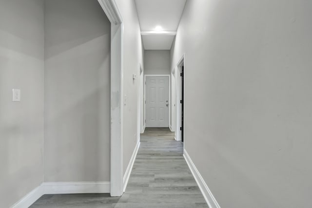 corridor with light hardwood / wood-style floors