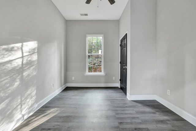 spare room featuring ceiling fan and dark hardwood / wood-style flooring