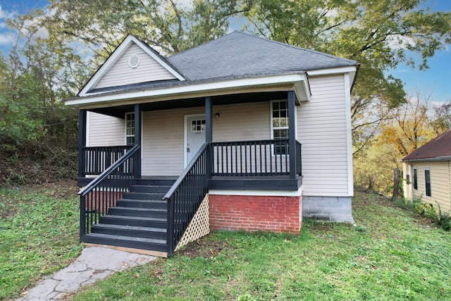 bungalow-style house featuring a front lawn and covered porch