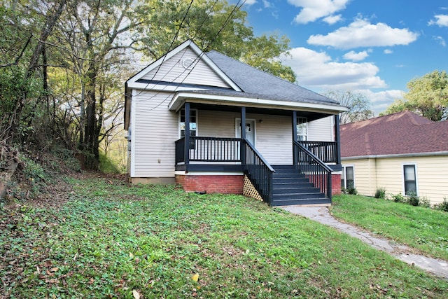 bungalow-style home featuring a porch and a front lawn