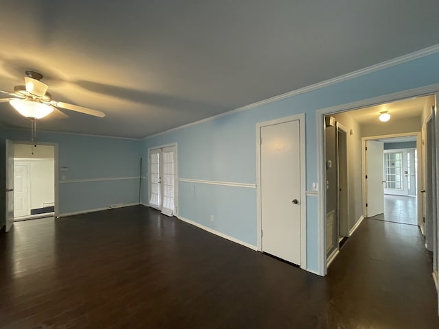 unfurnished room with crown molding, dark hardwood / wood-style flooring, ceiling fan, and french doors