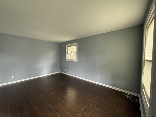 unfurnished room with dark hardwood / wood-style floors