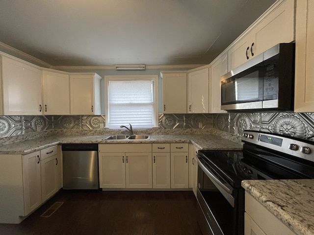 kitchen with light stone countertops, sink, stainless steel appliances, dark hardwood / wood-style floors, and decorative backsplash