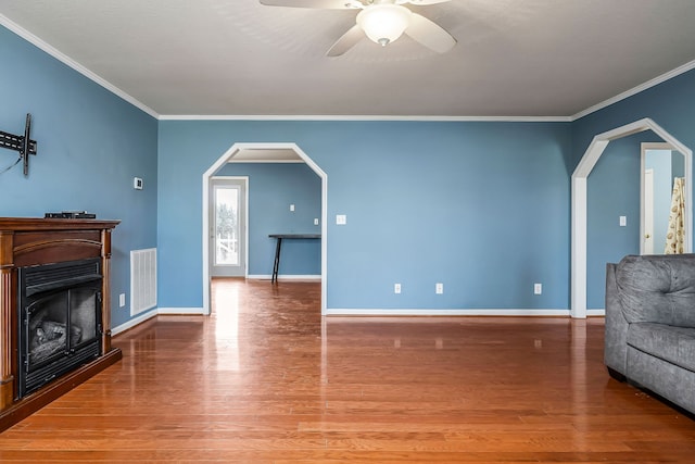 living room featuring ceiling fan, wood-type flooring, and ornamental molding