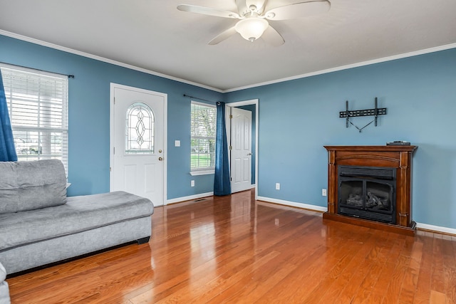 interior space with hardwood / wood-style floors, ceiling fan, and ornamental molding