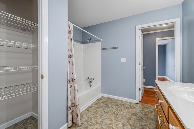 bathroom featuring tile patterned flooring, vanity, crown molding, and shower / tub combo with curtain