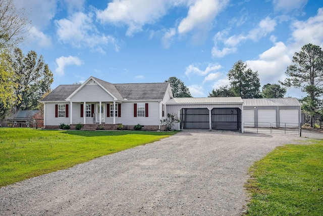 view of front of property featuring an outbuilding, covered porch, a front yard, and a garage