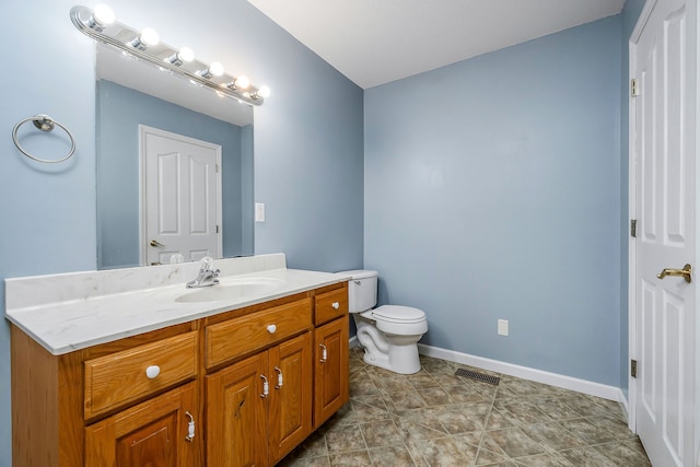 bathroom featuring tile patterned floors, vanity, and toilet