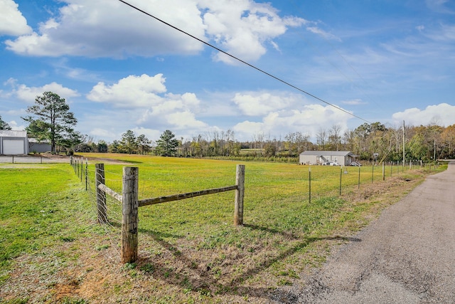 view of yard with a rural view