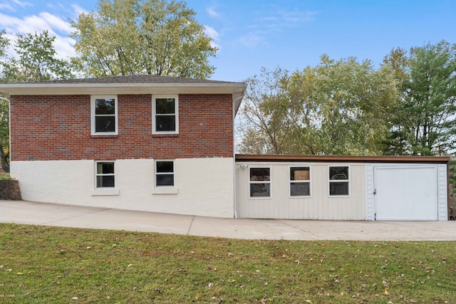 back of house with a patio area and a lawn