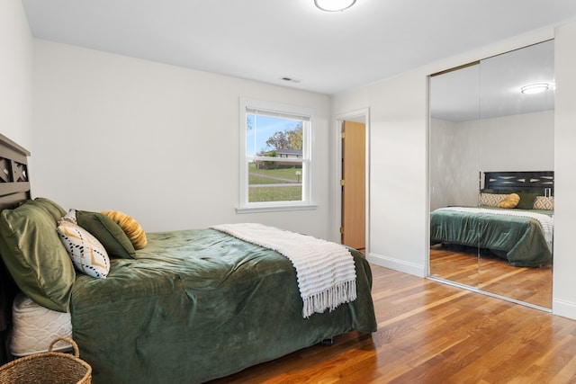 bedroom featuring hardwood / wood-style floors and a closet