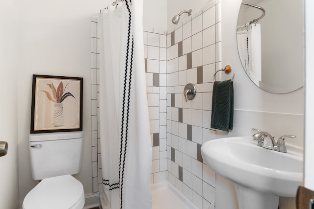 bathroom with sink, toilet, and walk in shower