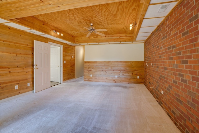 spare room featuring wood ceiling, light carpet, wooden walls, and brick wall