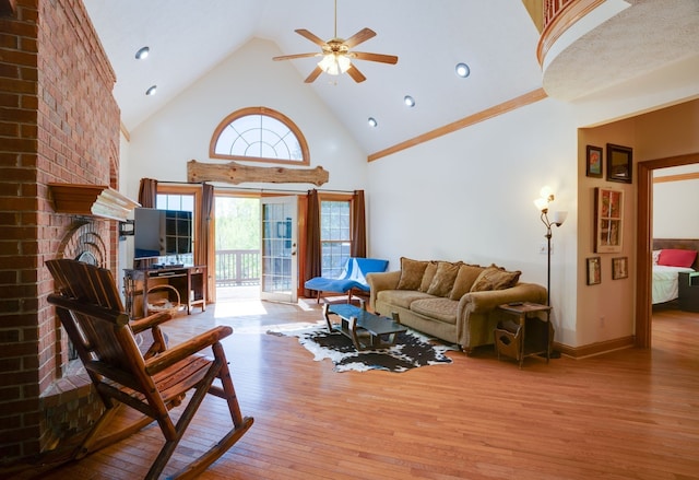 living room with a fireplace, high vaulted ceiling, light hardwood / wood-style flooring, and ceiling fan