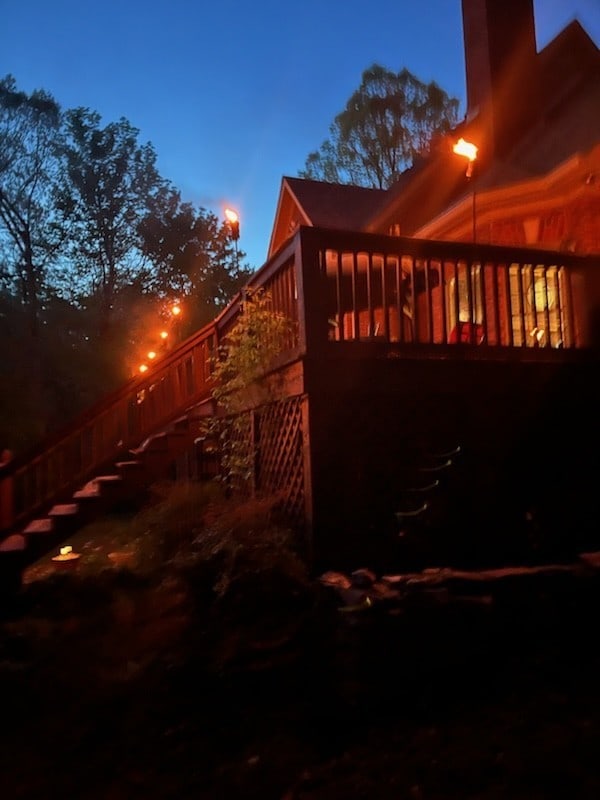 property exterior at dusk with a wooden deck