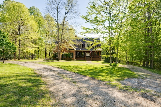 view of front facade featuring covered porch and a front yard