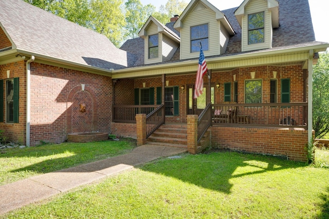 cape cod house featuring a front lawn and a porch