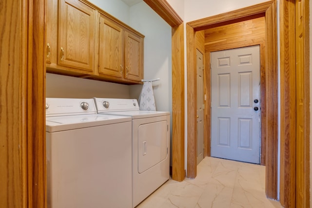 laundry area featuring washer and dryer and cabinets