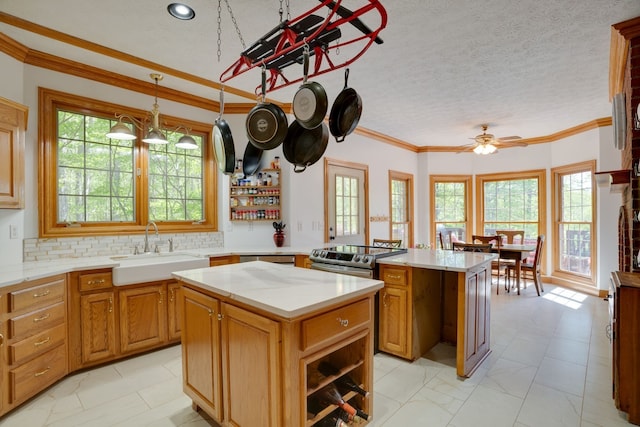 kitchen featuring a textured ceiling, a center island, a healthy amount of sunlight, and sink