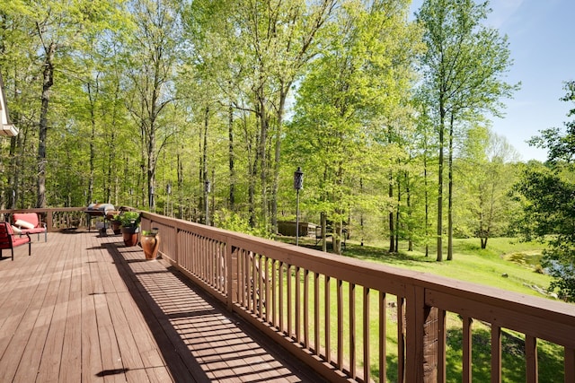 wooden terrace featuring a yard