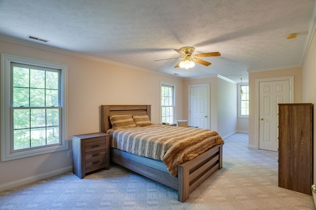 bedroom with ceiling fan, light colored carpet, and multiple windows