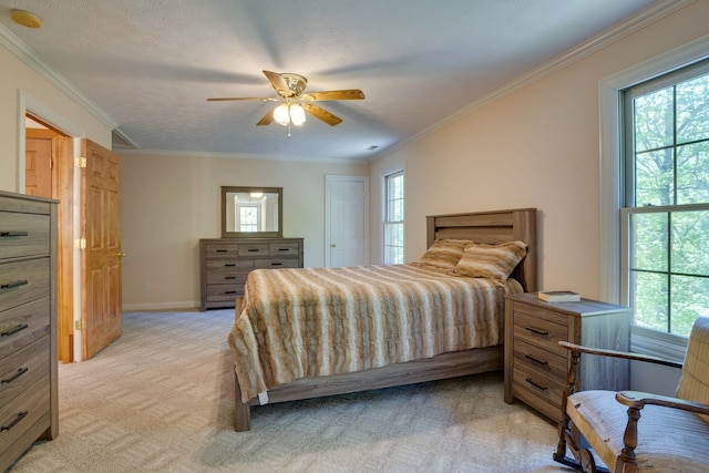 carpeted bedroom featuring ceiling fan, ornamental molding, a textured ceiling, and multiple windows