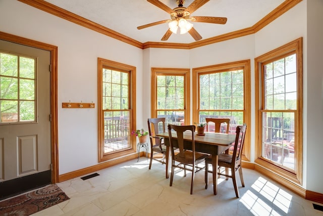 dining room featuring plenty of natural light, crown molding, and ceiling fan