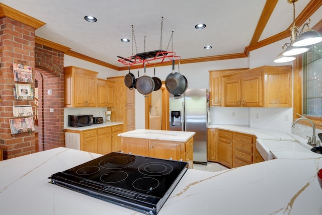 kitchen featuring sink, a center island, hanging light fixtures, crown molding, and black appliances