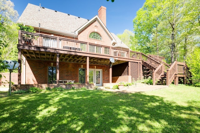 back of property featuring a deck and a yard