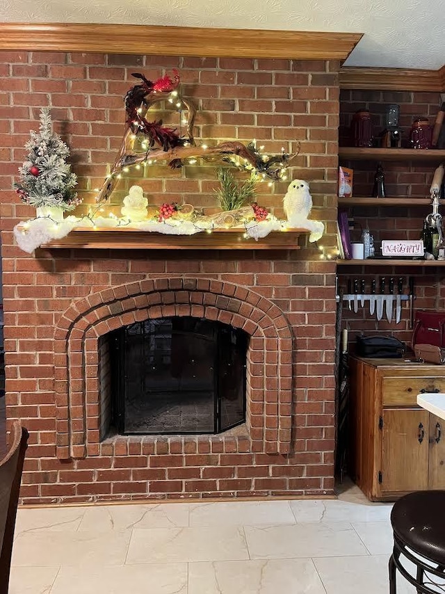 details with a textured ceiling and a brick fireplace