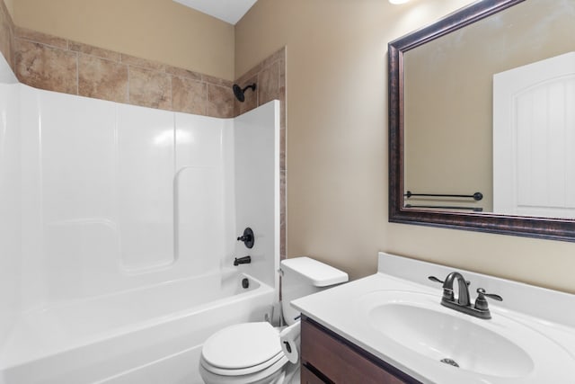 full bathroom with vanity, tiled shower / bath combo, and toilet