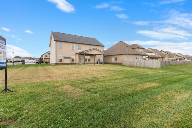 back of property featuring a lawn