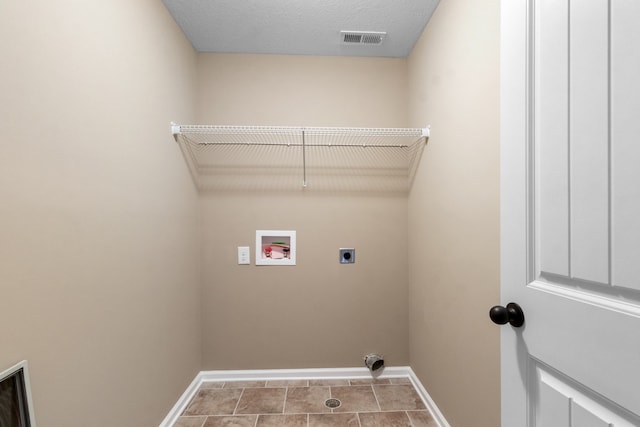 laundry room with hookup for an electric dryer, a textured ceiling, tile patterned floors, and washer hookup