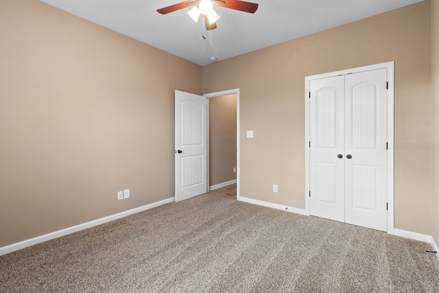 unfurnished bedroom with ceiling fan, a closet, and carpet