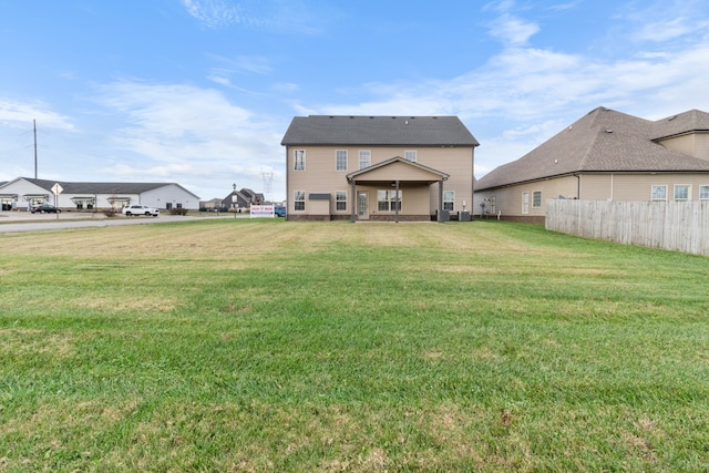 back of property with a lawn